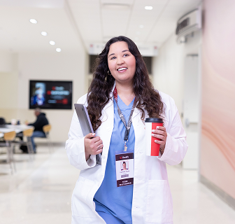 Woman in scrubs and lab coat