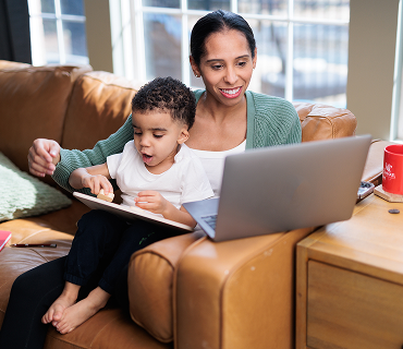 Mom studying with child on her lap