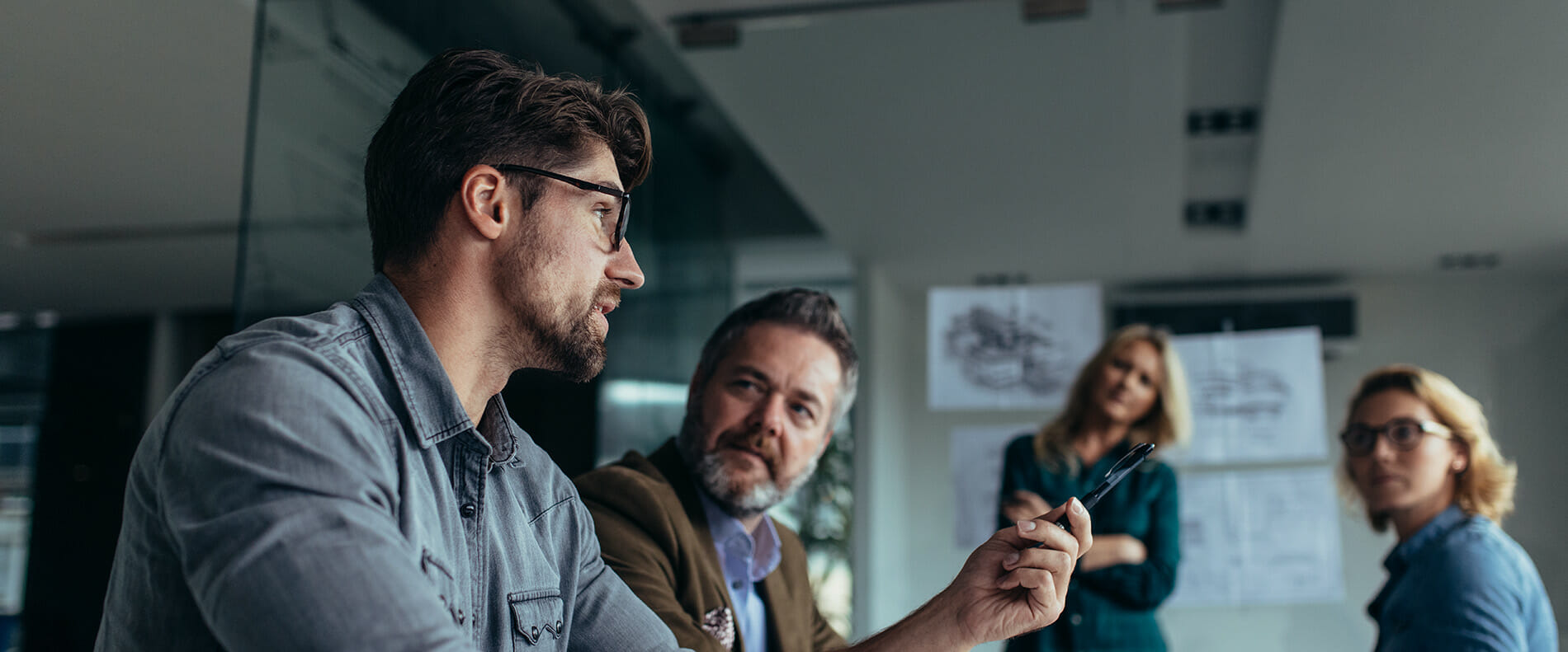 Four communication professionals in a meeting.