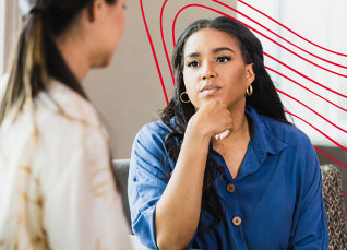 Social worker engaged in a thoughtful conversation with a client during a counseling session.