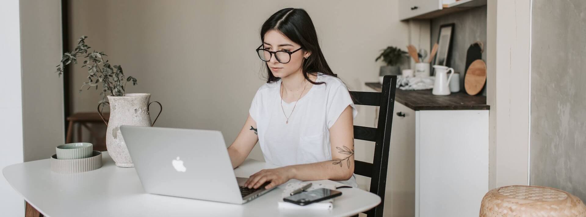 Bachelor of Professional Studies student doing homework on an Apple laptop.