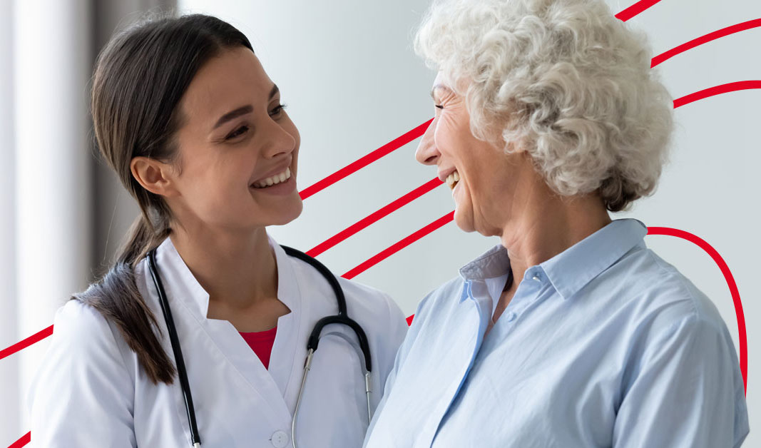 Nurse practitioner performing a checkup with a stethoscope on an older female patient during a routine wellness visit in a clinic.