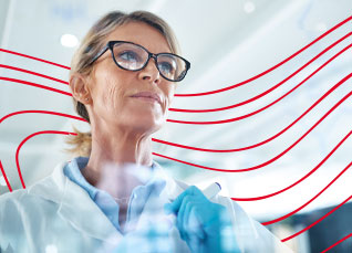 Research professional studying information on a transparent digital display in a laboratory.