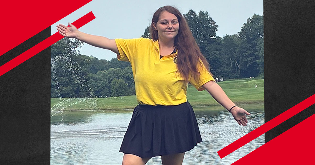 UC Online student standing outdoors with arms outstretched in front of a pond and grassy landscape, framed by red and black graphic accents.