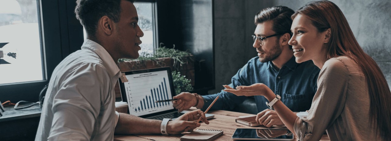 Business accounting technology professionals discussing financial reports.