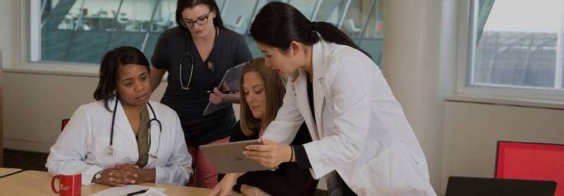 A health information systems professional is teaching students.