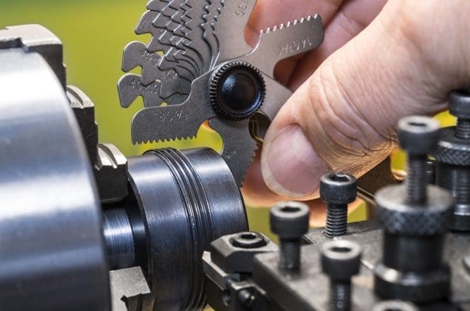 Closeup of a Robotics engineer working on serrated gears.