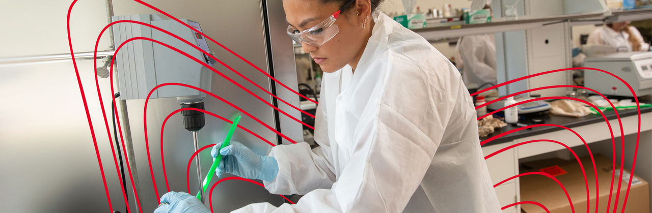 Scientist in lab conducting cosmetic formulation research.