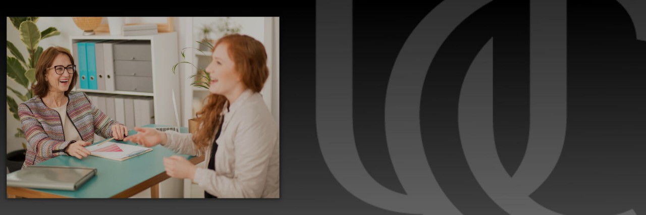 Masters in Health and Wellness Management student and professor interacting.