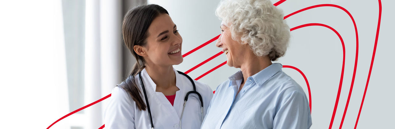 Nurse practitioner performing a checkup with a stethoscope on a female patient during a routine wellness visit in a clinic.