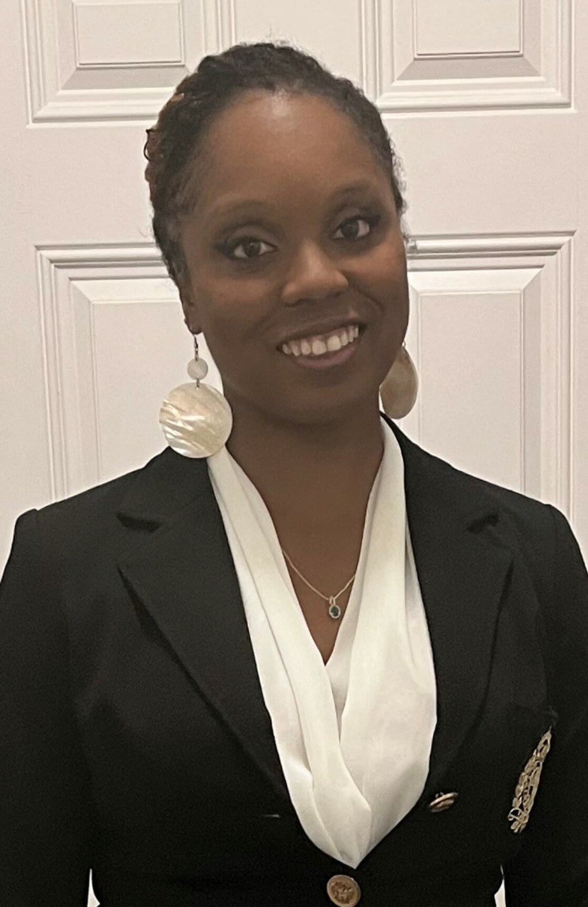UC Medical Laboratory Sciences student Michaela posing in front of a white door.