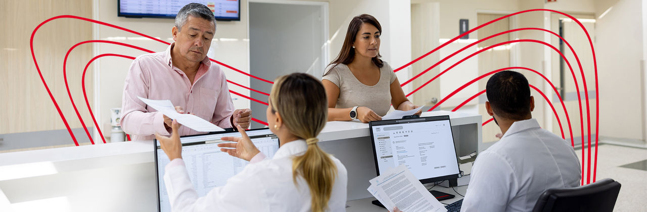Two men and two women working at healthcare registration area.