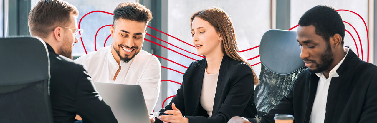 A group of professionals collaborates around a laptop, reviewing digital marketing data and performance metrics.