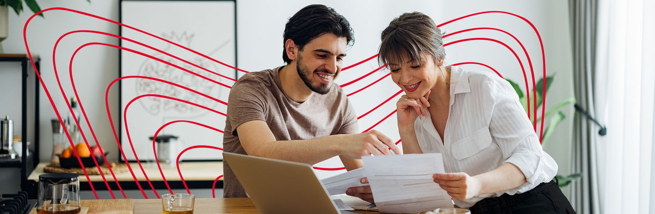 Two individuals review personal financial documents together, focusing on individual tax planning and preparation.