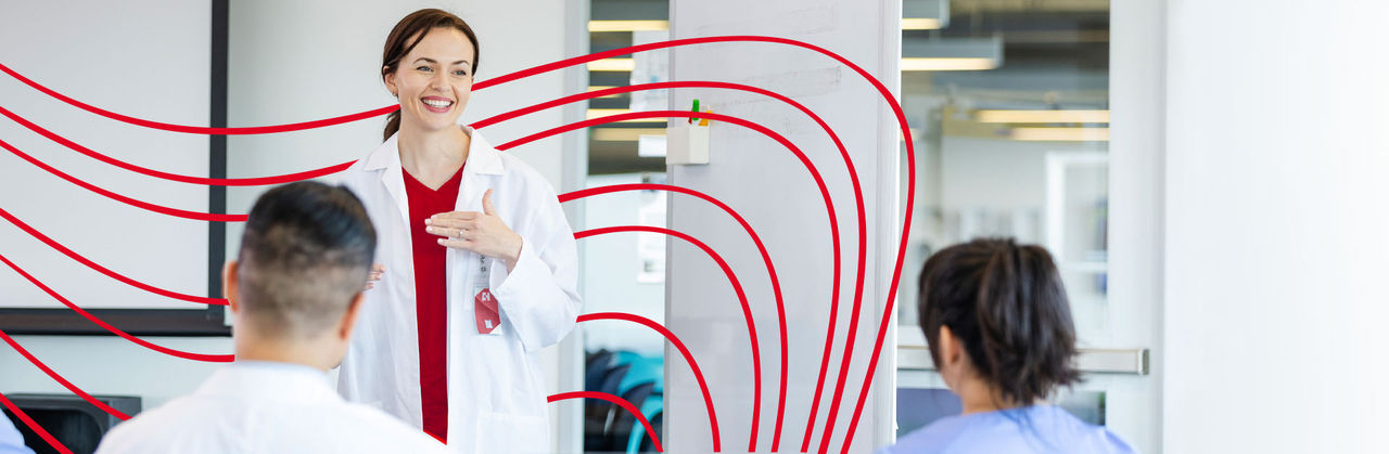 A female nurse teaching a group of nursing students
